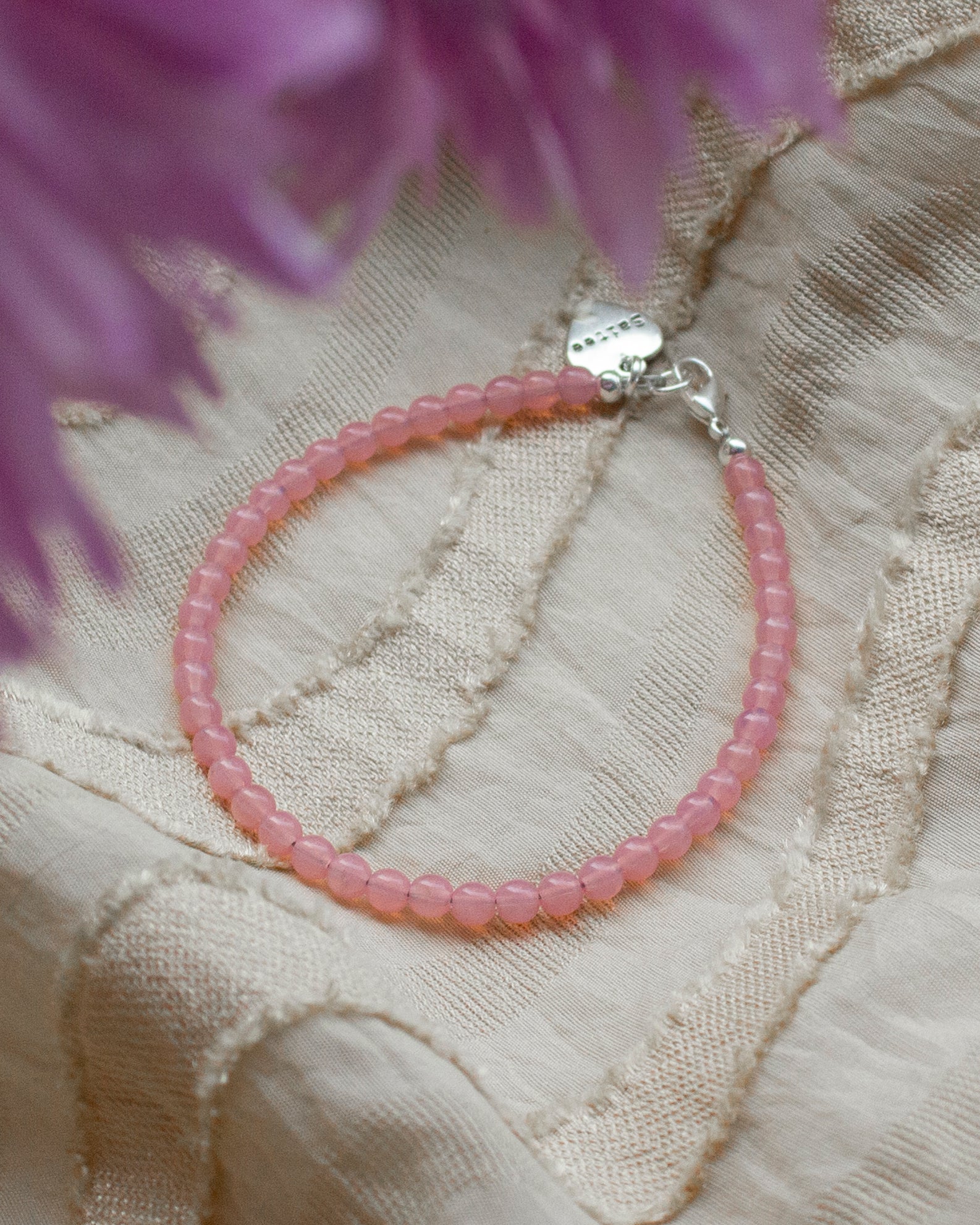 koraalroze kralenarmbandje met hartjes bedel met bloem