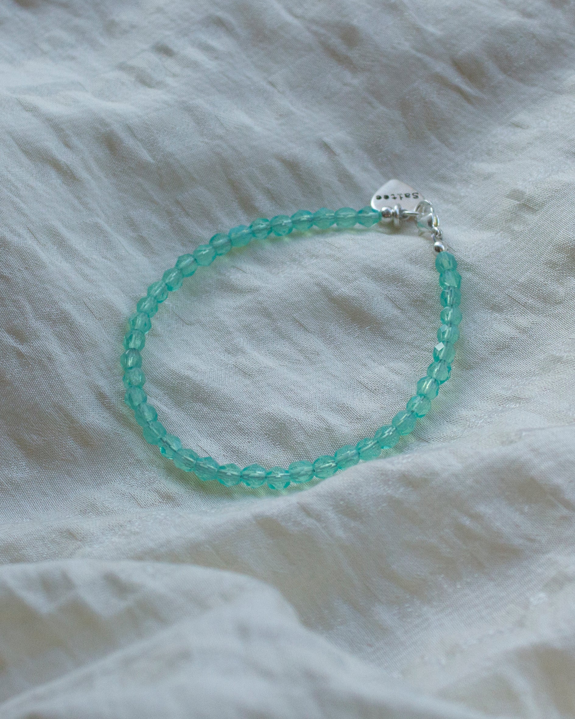 aqua kralenarmbandje met hartjesbedel