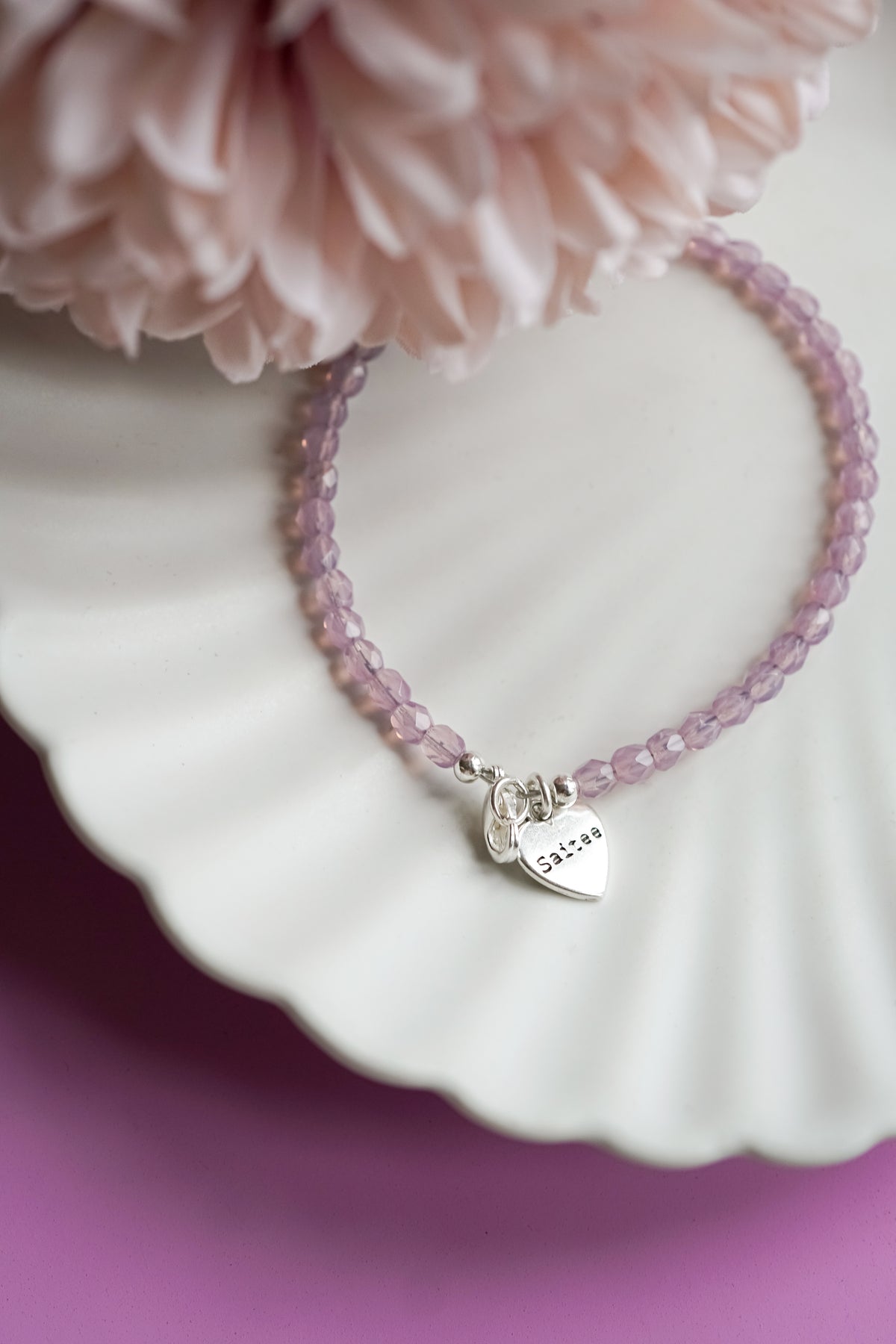 lila roze kralenarmbandje met hartjesbedel